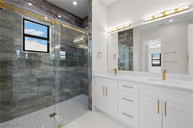 bathroom with vanity and a shower with shower door