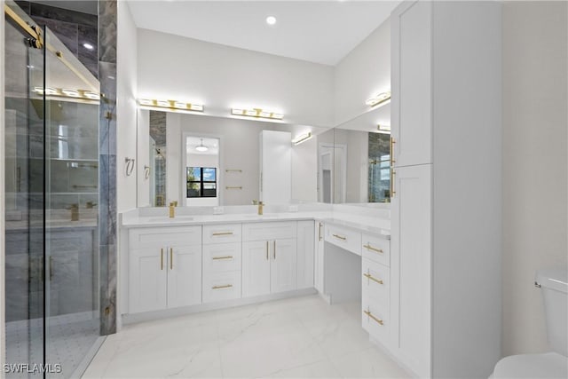 bathroom featuring a shower with door and vanity