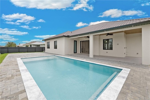 back of house featuring a fenced in pool, ceiling fan, and a patio area