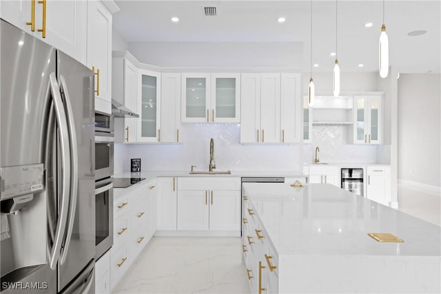 kitchen with sink, hanging light fixtures, stainless steel refrigerator with ice dispenser, wine cooler, and white cabinets