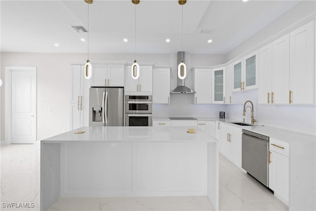 kitchen featuring hanging light fixtures, a kitchen island, appliances with stainless steel finishes, and sink