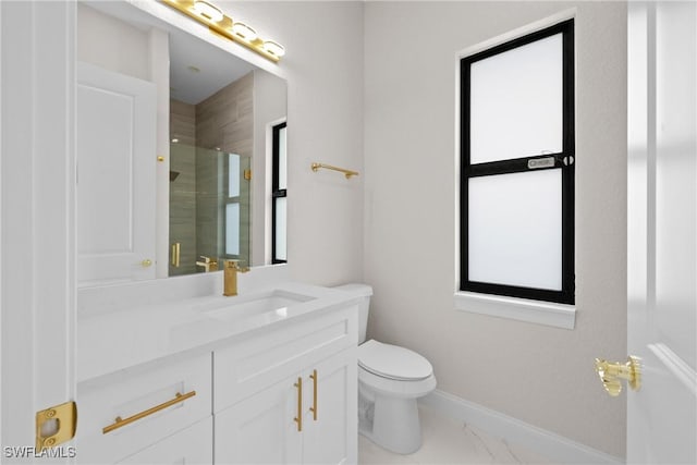 bathroom with a shower with door, vanity, and toilet