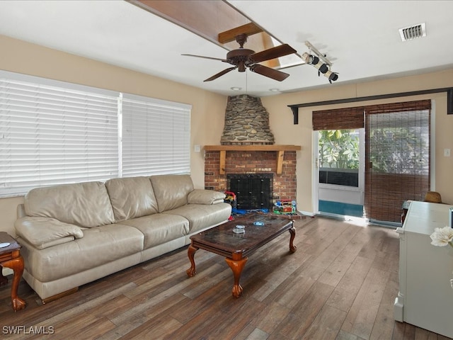 living room featuring hardwood / wood-style flooring, a fireplace, and ceiling fan