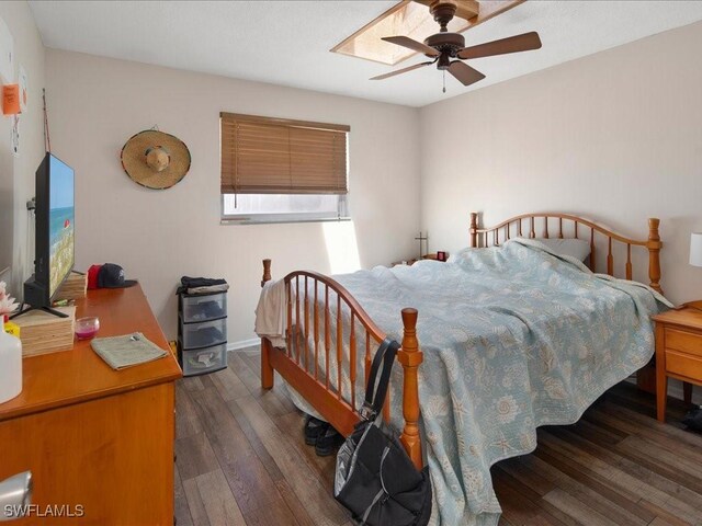 bedroom with ceiling fan and dark wood-type flooring