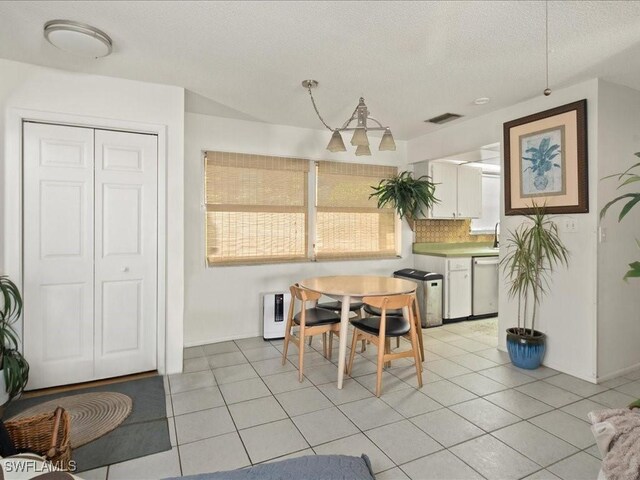 tiled dining area featuring a textured ceiling