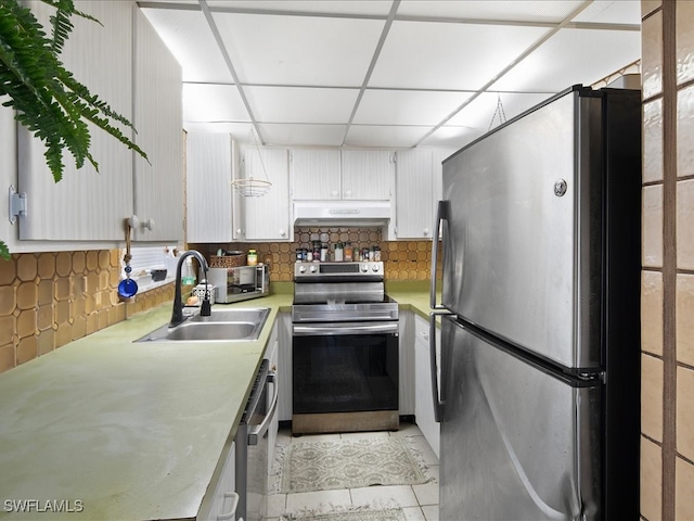 kitchen featuring light tile patterned flooring, sink, tasteful backsplash, premium range hood, and stainless steel appliances