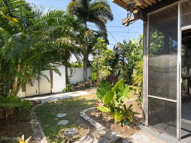 view of yard featuring a sunroom and an outdoor structure