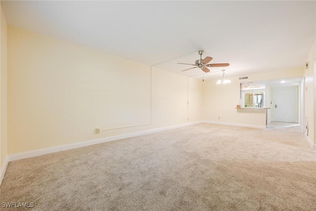 2504 SE 16th Pl Unit 101, Cape Coral, FL 33904 - empty room featuring light colored carpet, a ceiling fan, baseboards, and a chandelier