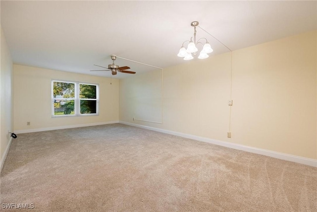 2504 SE 16th Pl Unit 101, Cape Coral, FL 33904 - empty room with light colored carpet, a ceiling fan, baseboards, and a chandelier