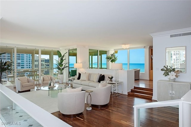 living room featuring a water view, crown molding, expansive windows, and dark wood-type flooring