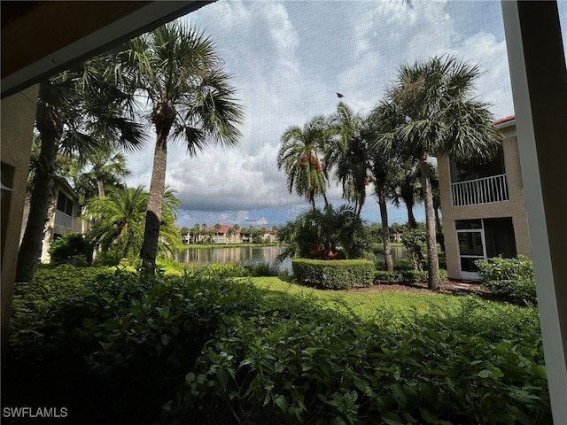 view of yard with a balcony and a water view