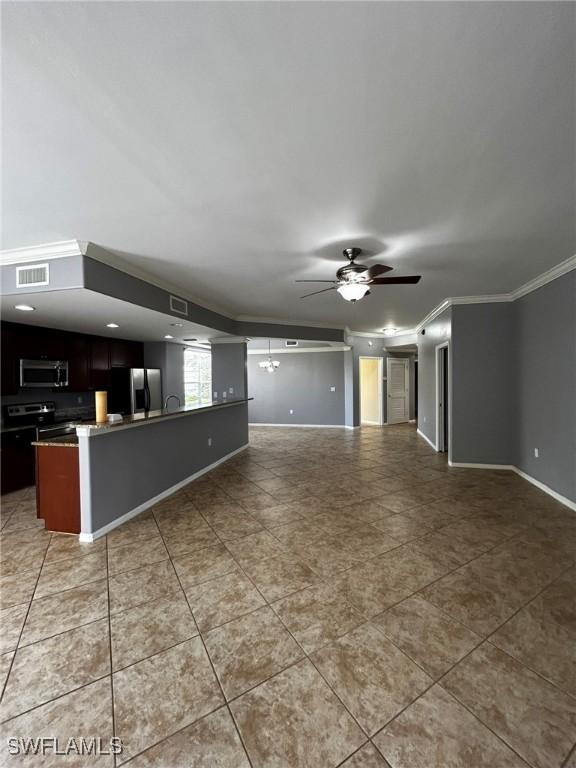 unfurnished living room with ceiling fan, light tile patterned floors, and crown molding