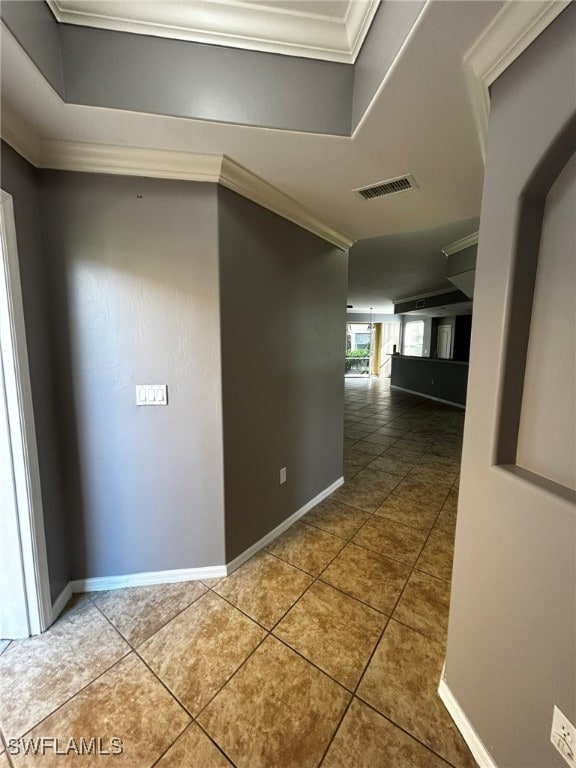 corridor featuring tile patterned flooring and ornamental molding