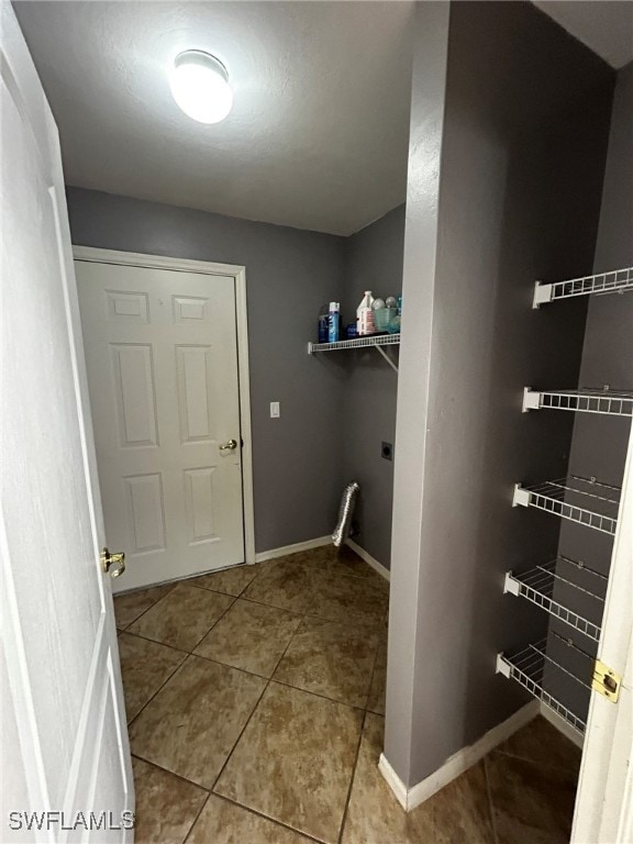 clothes washing area featuring light tile patterned floors