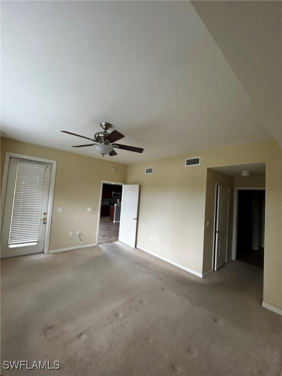 carpeted empty room featuring ceiling fan