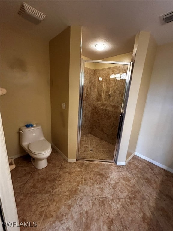 bathroom with toilet and a shower with shower door