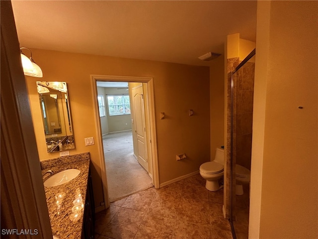 bathroom featuring tile patterned floors, walk in shower, vanity, and toilet