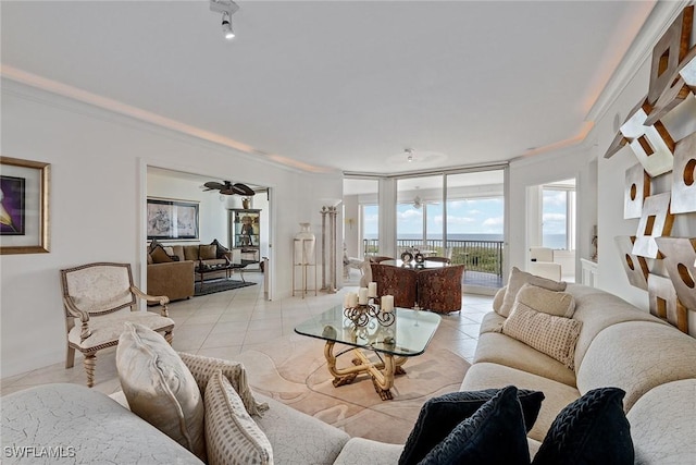 living room featuring floor to ceiling windows, crown molding, light tile patterned floors, and ceiling fan