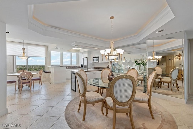 dining room featuring a chandelier, light tile patterned floors, a raised ceiling, and crown molding