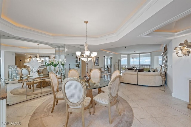 tiled dining area with a chandelier, ornamental molding, and a tray ceiling