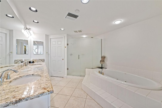 bathroom with plus walk in shower, vanity, and tile patterned floors