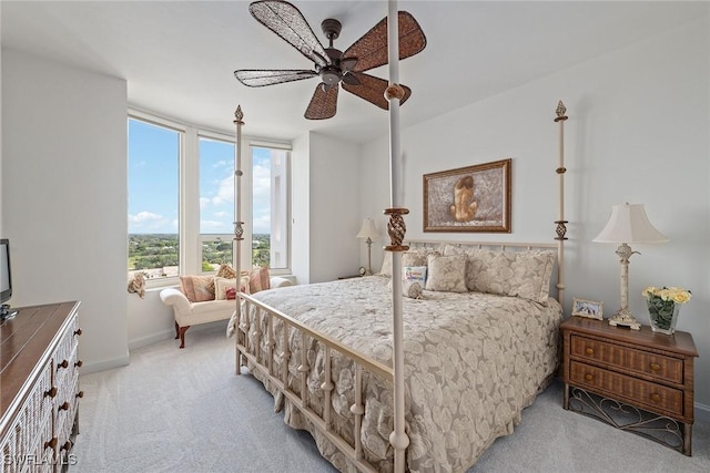 bedroom with ceiling fan and light colored carpet