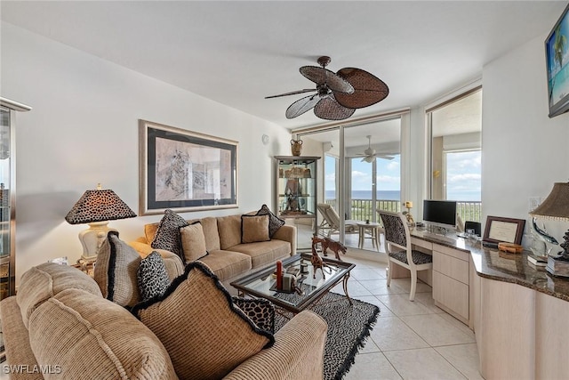 tiled living room with floor to ceiling windows and built in desk