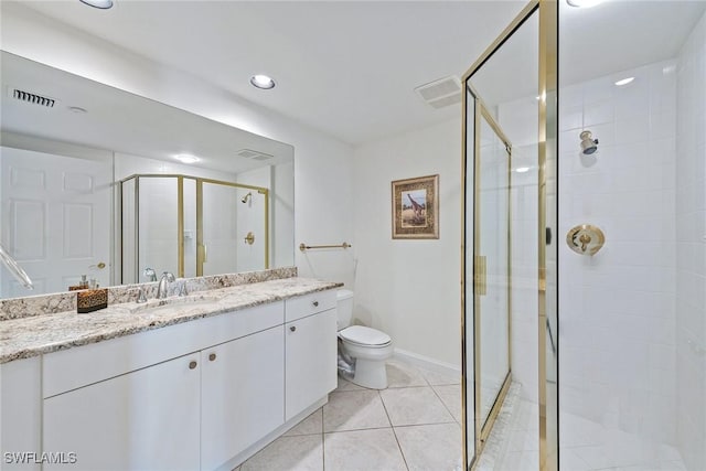 bathroom with tile patterned floors, vanity, toilet, and an enclosed shower