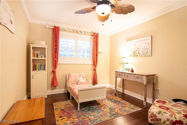 sitting room featuring ceiling fan, crown molding, and dark wood-type flooring