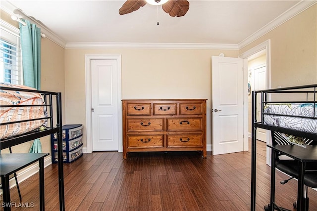 bedroom with dark wood-style floors, crown molding, baseboards, and ceiling fan