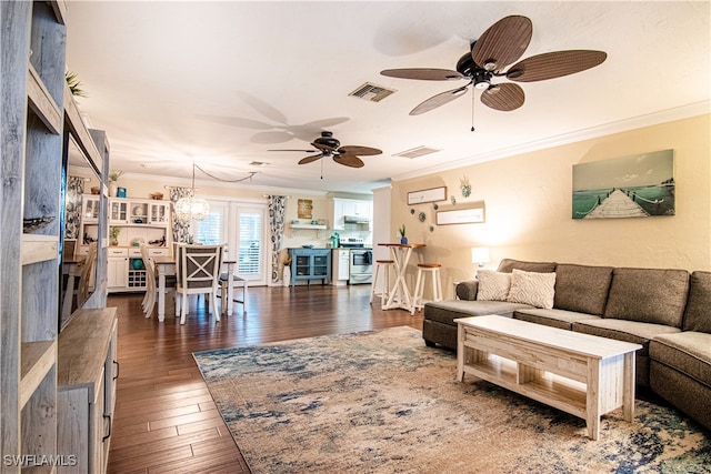 living room featuring ceiling fan with notable chandelier, ornamental molding, and dark hardwood / wood-style floors