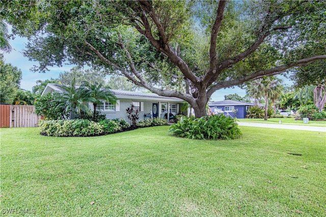 ranch-style house featuring a front lawn