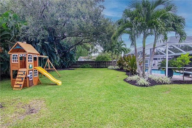 view of yard with a fenced backyard, a playground, a lanai, and a fenced in pool