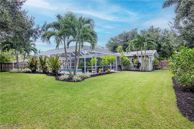 view of yard featuring a fenced backyard, a lanai, and a fenced in pool