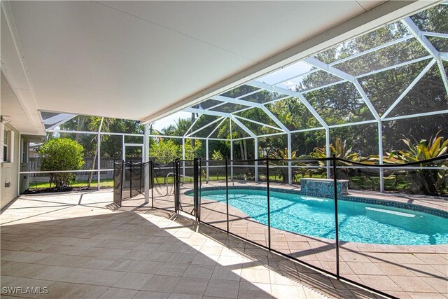 1316 Sunbury Dr, Fort Myers, FL 33901 - view of swimming pool with fence, a patio area, a fenced in pool, and glass enclosure