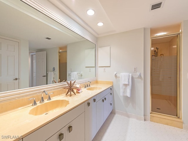 bathroom with tile patterned flooring, vanity, and an enclosed shower