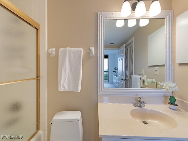 full bathroom with enclosed tub / shower combo, toilet, and sink