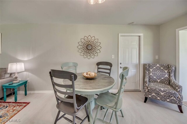 dining area with light hardwood / wood-style floors