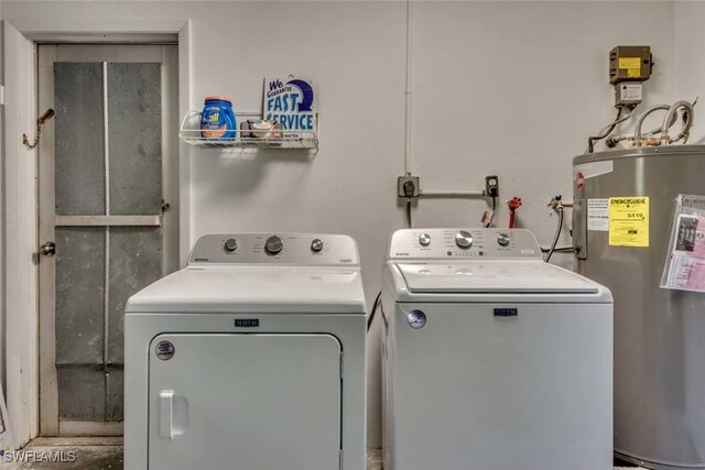 washroom with water heater and separate washer and dryer