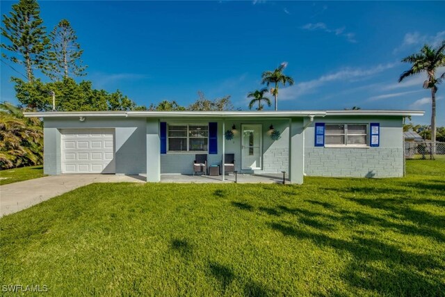 single story home featuring a garage and a front lawn