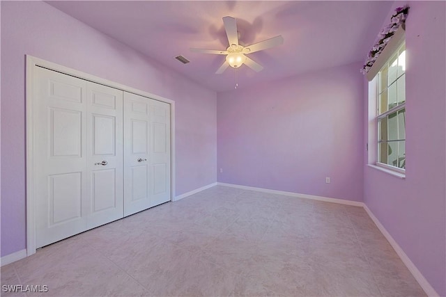 unfurnished bedroom with a ceiling fan, a closet, visible vents, and baseboards