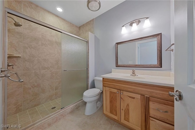 bathroom with toilet, a stall shower, tile patterned flooring, and vanity