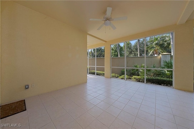 unfurnished sunroom featuring a ceiling fan