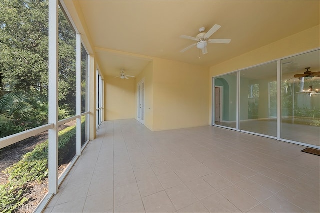 unfurnished sunroom with ceiling fan and a healthy amount of sunlight