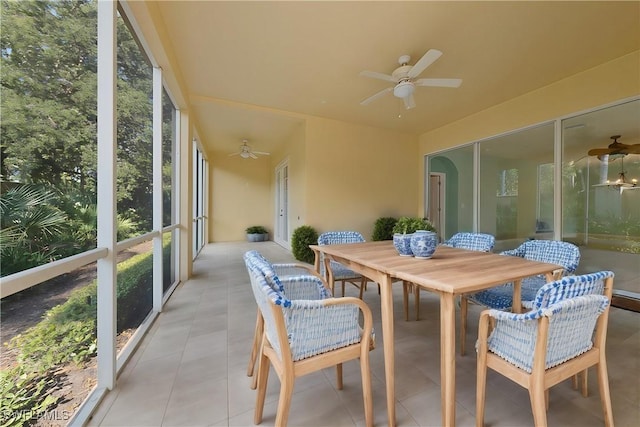 sunroom featuring a ceiling fan