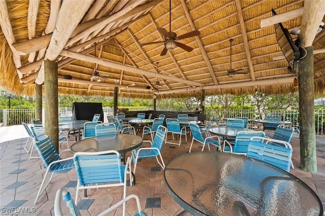 view of patio featuring a ceiling fan, outdoor dining area, and a gazebo