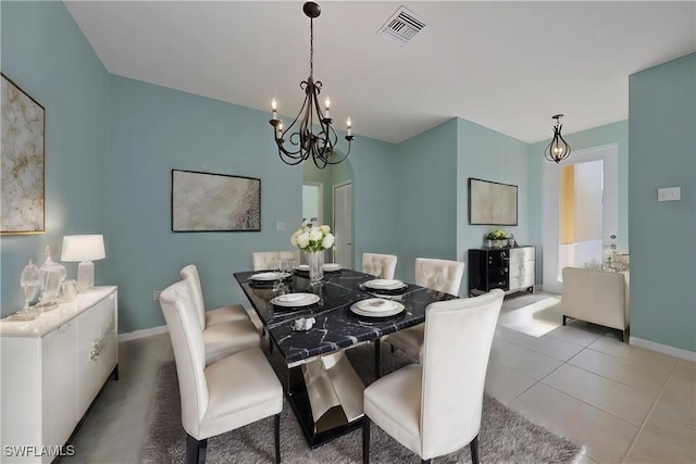 dining room with an inviting chandelier, tile patterned floors, visible vents, and baseboards