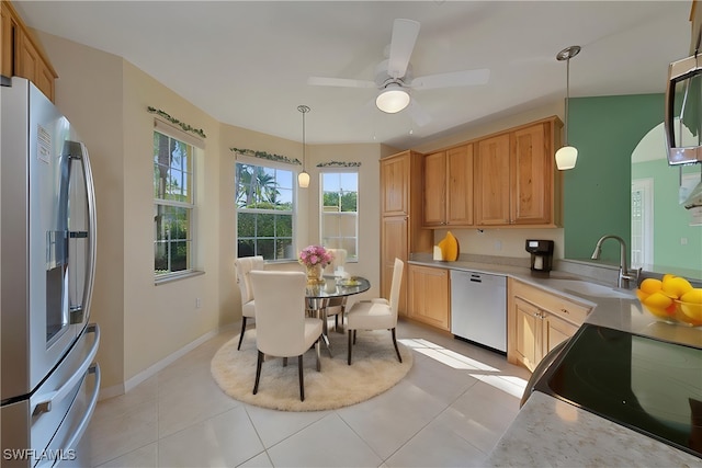 kitchen with decorative light fixtures, fridge, dishwashing machine, light tile patterned floors, and ceiling fan