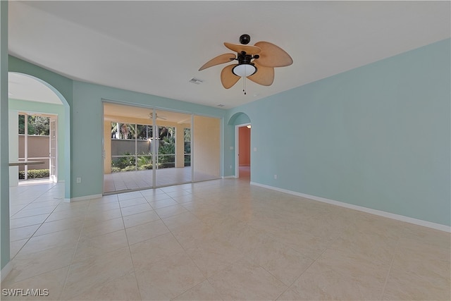 empty room with ceiling fan and light tile patterned floors