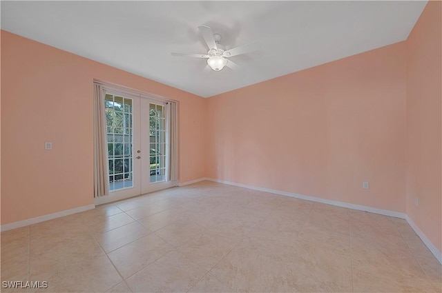 empty room with baseboards, a ceiling fan, and french doors